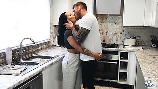 Brunette MILF with big tits fucked in the kitchen by a tattooed stud