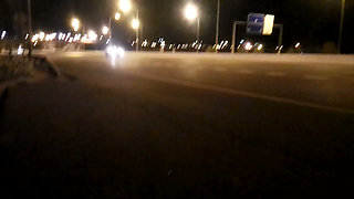 Naked on the road in front of traffic at night