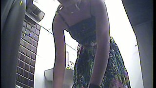 Gorgeous blonde white girl in sexy dress pisses in the toilet room