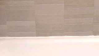 Blonde MILF peeing in the bathtub