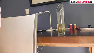 Hot brunette pisses on a glass after stroking clit hard