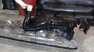The bondage slave receives the dominatrix's saliva and licks her feet