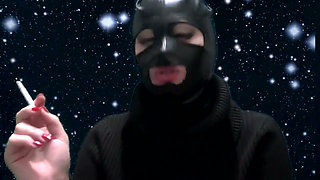Smoking and teasing you in a latex mask